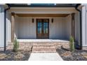 Charming entryway with brick steps, wood columns, and a double front door at 2321 Ivey Church Rd, Maiden, NC 28650