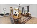 Bright living room with a fireplace, comfortable seating, and a stylish area rug at 4114 Rutgers Ave, Charlotte, NC 28206
