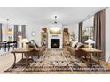 Bright living room with a fireplace, plush seating, and stylish decor at 4114 Rutgers Ave, Charlotte, NC 28206