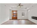 Bright living room featuring modern fireplace, tray ceiling, and hardwood floors at 501 Everette St, Monroe, NC 28112