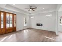 Bright living room featuring modern fireplace, tray ceiling, and hardwood floors at 501 Everette St, Monroe, NC 28112