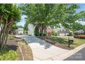 Long driveway leading to a charming home with mature trees at 6141 Abergele Ln, Matthews, NC 28104