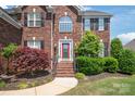 Charming brick home with a welcoming red front door at 6141 Abergele Ln, Matthews, NC 28104