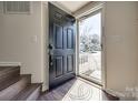 Welcoming foyer with a dark wood floor and door leading to the outside at 6374 Windsor Gate Ln, Charlotte, NC 28215
