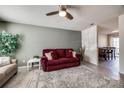 Inviting living room featuring tile floors, neutral walls, and a ceiling fan at 6374 Windsor Gate Ln, Charlotte, NC 28215