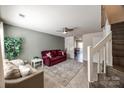 Inviting living room featuring tile floors, neutral walls, and a ceiling fan at 6374 Windsor Gate Ln, Charlotte, NC 28215