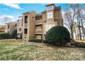 Condo building featuring multiple levels with balconies, complemented by lush greenery, set in a lakefront community at 667 Portside Dr, Davidson, NC 28036