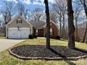 Inviting home exterior with a well-maintained lawn and mulched flower bed at 7507 Reedy Creek Rd, Charlotte, NC 28215