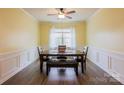 Bright dining room features wood floors, a large window, and modern lighting at 8828 Powder Works Dr, Huntersville, NC 28078