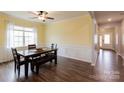 Bright dining room features wood floors, large window, and wainscoting at 8828 Powder Works Dr, Huntersville, NC 28078