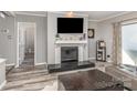 Comfortable living room with a fireplace, television, and a gray accent wall, perfect for relaxing at 9035 J M Keynes Dr # 33, Charlotte, NC 28262