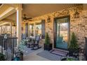 Charming front porch features brick accents, comfortable seating, and decorative elements at 944 Clear Creek Cir, Lincolnton, NC 28092