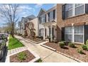 Street view of attractive townhomes with manicured lawns and sidewalks; a desirable community at 10430 Alexander Martin Ave, Charlotte, NC 28277