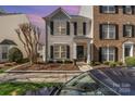 Beautiful two-story home with a landscaped yard, dark shutters, and sidewalk approach at 10430 Alexander Martin Ave, Charlotte, NC 28277