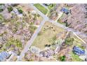 Birds-eye view displaying a peaceful residential area, with this home on a spacious lot amidst tree-lined streets at 105 Partridge Bluff Ne Dr, Concord, NC 28025