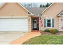 Welcoming front entrance with a decorative door, American flag, green shutters, and manicured landscaping at 121 Yorkshire Dr, Salisbury, NC 28144