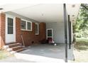 Attached carport with a concrete floor, brick wall, and convenient access to the house at 1606 Mt Gallant Rd, Rock Hill, SC 29732