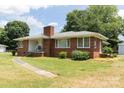 Quaint brick house with a manicured lawn and walkway leading to the front entrance at 1606 Mt Gallant Rd, Rock Hill, SC 29732