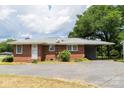 Brick home featuring a convenient carport and spacious paved driveway for easy parking at 1606 Mt Gallant Rd, Rock Hill, SC 29732