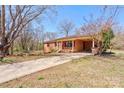 Charming brick home featuring a covered carport and a long driveway, nestled on a tree-filled lot at 200 South Fork Dr, Shelby, NC 28152