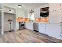 Well-lit kitchen featuring brick backsplash, white cabinets, and stainless steel appliances at 200 South Fork Dr, Shelby, NC 28152