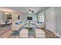 Bright living room featuring neutral decor, contemporary furnishings, light wood flooring, and a ceiling fan at 200 Southfork Dr, Shelby, NC 28152