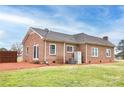 Rear exterior view of brick home with a fenced yard at 2005 Douglas Rd, Lancaster, SC 28720