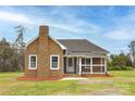 Cozy brick home with manicured lawn and covered porch at 2005 Douglas Rd, Lancaster, SC 28720