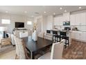 Open concept living space connects the dining area and kitchen with a TV and natural light at 2106 Morgan Hills Dr, Albemarle, NC 28001