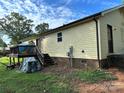 Exterior showcasing a deck, stairs, and the rear of the home with siding and a brick foundation at 211 Honeycutt Rd, Troutman, NC 28166