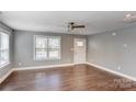 Bright living room featuring hardwood floors, a ceiling fan, and a front door with window accents at 248 Kerr Nw St, Concord, NC 28025