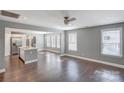 Open concept living room with hardwood floors leading to a modern kitchen and dining area at 248 Kerr Nw St, Concord, NC 28025