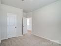 Bright bedroom with neutral carpet, white walls, and natural light at 2639 Tillman St, Monroe, NC 28112