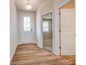 Inviting entryway featuring wood-look flooring and a view into the adjacent room at 2639 Tillman St, Monroe, NC 28112