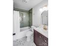 Updated bathroom features a shower-tub combination with green tile and modern fixtures over marble tile floor at 327 Berry St, Rock Hill, SC 29732