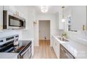 Modern kitchen featuring stainless steel appliances, white cabinetry, and sleek countertops for a clean look at 327 Berry St, Rock Hill, SC 29732