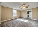 Cozy bedroom with neutral walls, plush carpet, and a ceiling fan, creating a comfortable and inviting space at 36 Brookline St, Great Falls, SC 29055