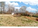 A brick ranch home on a well-maintained lawn, showcasing a stone-bordered planting area at 4014 Linwood Rd, Gastonia, NC 28052