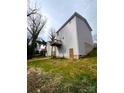 View of the backyard and the back of the home with a small porch at 421 Rocky Brook Dr, Shelby, NC 28150