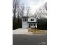 Charming two-story home featuring a covered porch, attached garage, and landscaped yard at 421 Rocky Brook Dr, Shelby, NC 28150