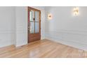 Elegant foyer with hardwood floors, white walls, modern lighting and a wood front door at 4227 Holly Ne Cir, Conover, NC 28613