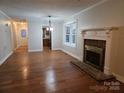 Inviting living room offers fireplace, hardwood floors and natural light at 446 Windsor Ln, Statesville, NC 28677