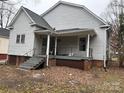 A covered back porch with steps leads to a large backyard at 517 Western Ave, Statesville, NC 28677