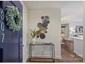 Inviting condo entryway featuring stylish decor, a modern console table, and a blue entry door with wreath at 718 W Trade St # 307, Charlotte, NC 28202