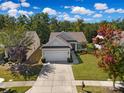 Charming single-story home with a two-car garage, manicured lawn, and mature trees at 8107 Crater Lake Dr, Indian Land, SC 29707