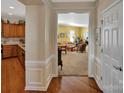 Open foyer showcasing hardwood floors that lead to a bright living room and modern kitchen at 8107 Crater Lake Dr, Indian Land, SC 29707