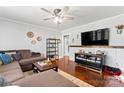 Comfortable living room featuring a plush brown sectional, hardwood floors, and a ceiling fan at 851 Gist Rd, Rock Hill, SC 29732