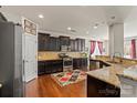 Well-equipped kitchen featuring dark cabinetry, granite countertops and stainless steel appliances at 10714 Sapphire Trl, Davidson, NC 28036