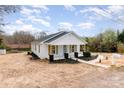 A beautifully remodeled house featuring a new landscape, roof and charming front porch at 108 Arlene Ave, Kannapolis, NC 28081