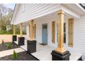Inviting front porch with craftsman columns and a light blue front door at 108 Arlene Ave, Kannapolis, NC 28081